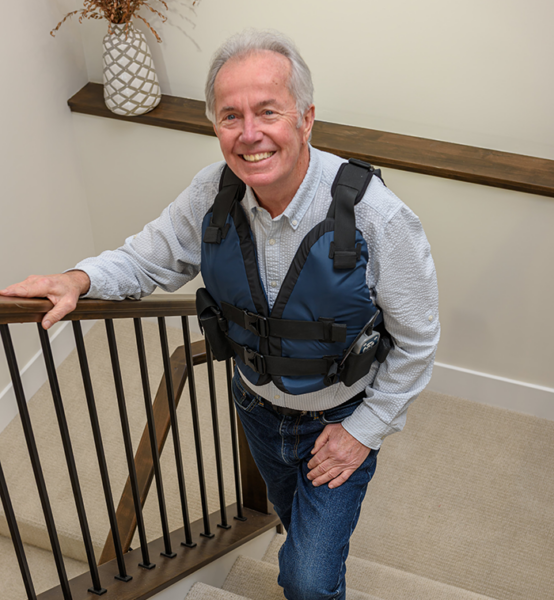 man walking upstairs with AffloVest on